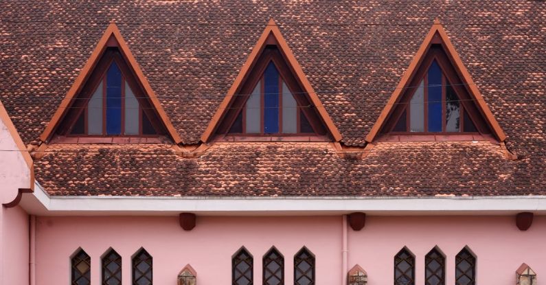 Domain - A pink building with three windows and a roof