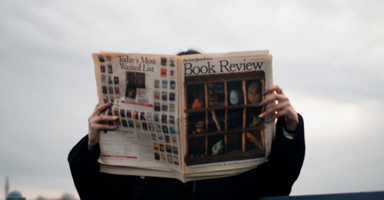 Updates - Person Holding White and Brown Newspaper