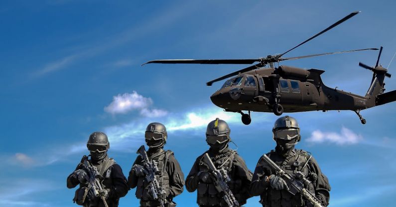 Attacks - Four Soldiers Carrying Rifles Near Helicopter Under Blue Sky